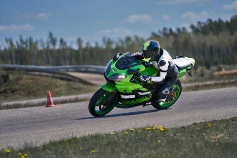 Motorcycle practice leaning into a fast corner on track 스톡 사진