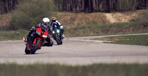 Motorcycle practice leaning into a fast corner on track Stock-Fotos