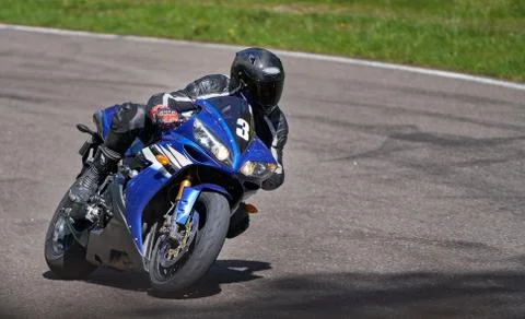 Motorcycle practice leaning into a fast corner on track. Stock-Fotos