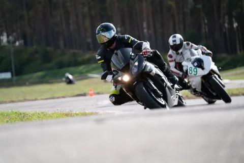 Motorcycle practice leaning into a fast corner on track Stockfoto's