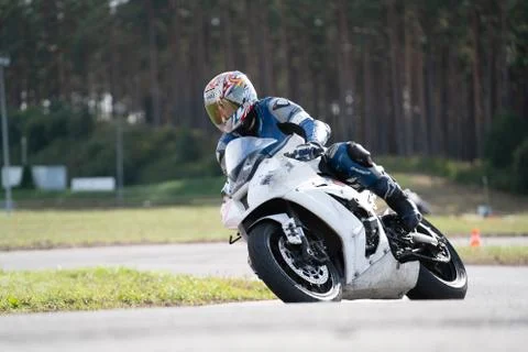 Motorcycle practice leaning into a fast corner on track Фото
