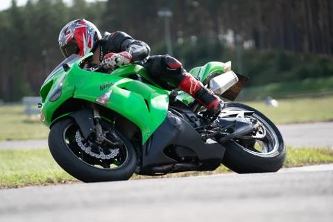 Motorcycle practice leaning into a fast corner on track 库存照片
