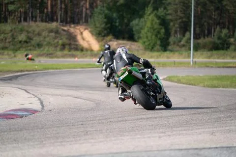 Motorcycle practice leaning into a fast corner on track Fotos Stock
