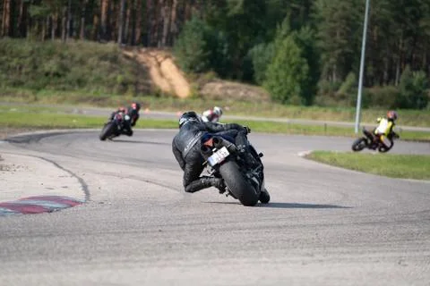 Motorcycle practice leaning into a fast corner on track Fotos Stock