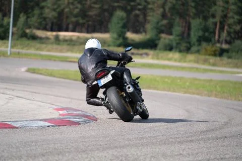Motorcycle practice leaning into a fast corner on track 库存照片