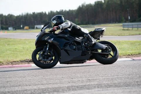 Motorcycle practice leaning into a fast corner on track 库存照片