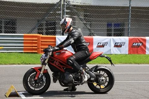 Motorcycle racer is preparing to start Фото