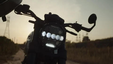 Motorcycle is in the rays of the sun on the off -road Stock Footage 253448387