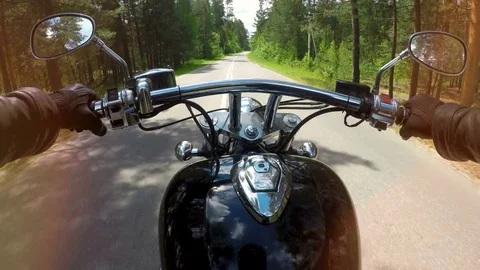 A motorcycle ride in the first view with handles, levers and mirrors visible. 4K Stock Footage