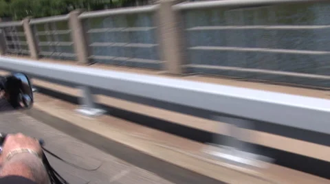 Motorcycle ride over a bridge Stock Footage 41296099