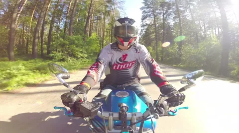 Motorcycle rider on a forest road Stock Footage 46703060