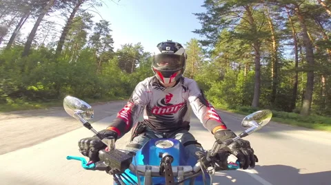 Motorcycle rider on a forest road Stock Footage 46703219