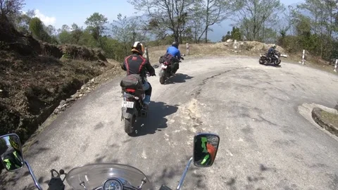 Motorcycle rider group on hill road Of Nepal Stock Footage