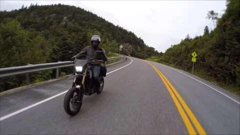 Motorcycle rider waives at camera on back of rider Stock Footage 87332484