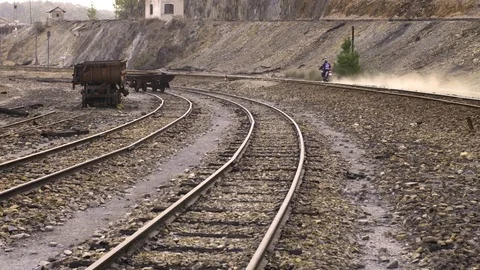Motorcycle rides along train tracks Stock Footage 81471282