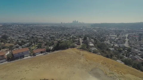 Motorcycle Rides Down Dirt Road Away From City Aerial View Stock Footage 78978941