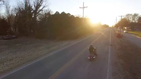 Motorcycle rides into the sunset 4K Stock Footage 99698154
