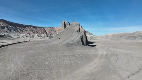 Motorcycle rides up unique hillside in the Caineville desert in Utah Stock Footage 165568199