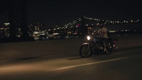Motorcycle rides with the view on Brooklyn bridge at night Video stock 79849684