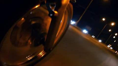 Motorcycle riding on a city road at night. Front wheel motorcycle close-up Stock Footage