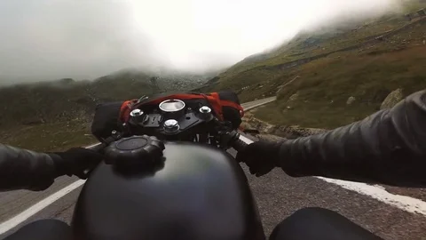 Motorcycle riding down the mountain road on a nice cloudy day. Stock Footage 78225492