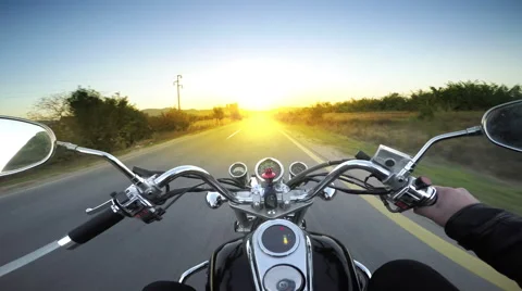 A motorcycle road adventure going forward to the sun in high speed. pov at su Stock Footage