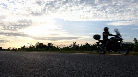 Motorcycle running on the road at sunset Stock Footage 113461469