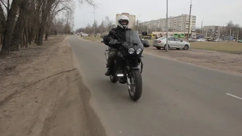 The motorcycle rushes down the road. Crane shot. Stock Footage 75861981