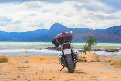 Motorcycle on a sandy beach Stock Photos