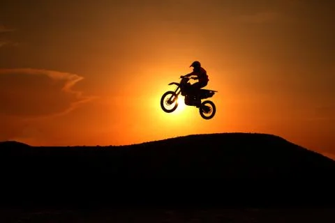 Motorcycle silhouette are jumping Stock Photos