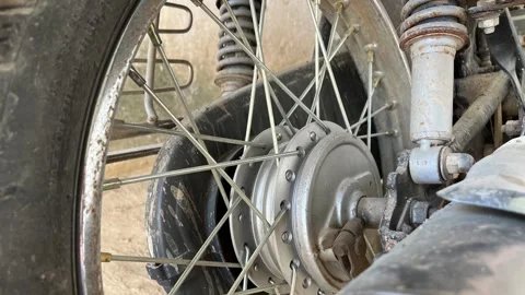 Motorcycle silver spokes, drum brake hub, and dual shock absorbers Stock Footage 328409180