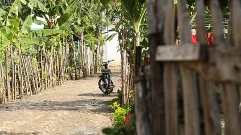 Motorcycle Sitting In Empty Third World Tropical Dirt Street 스톡 동영상 108578337