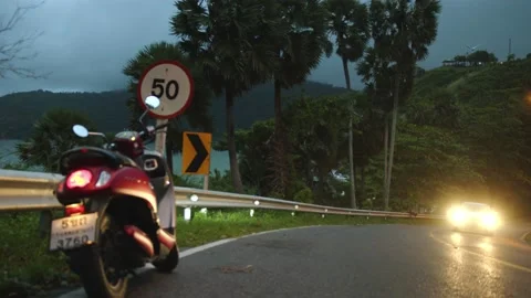 A motorcycle is standing on the curb with a blinking turn signal Stock Footage 223819557