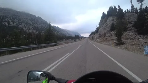 Motorcycle on a straight cloudy mountain road POV Stock Footage 201245492