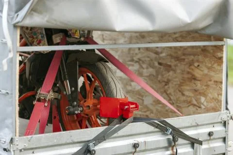 Motorcycle strapped in a trailer Фото