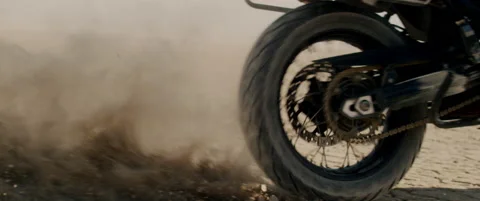 Motorcycle throws up cloud of desert dusk in slow motion Stock Footage 136497017