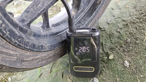 Motorcycle tires being inflated using an electric pump, close up Stock Footage 336831953