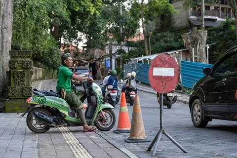 Motorcycle Traffic Outside Ubud Monkey Forest 스톡 사진