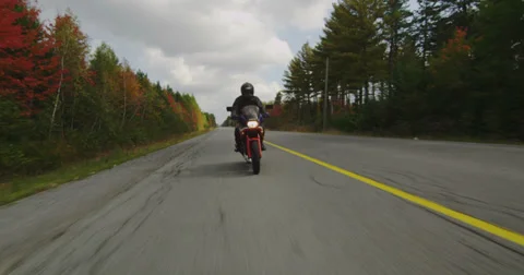 Motorcycle Travelling Down Empty Highway in Autumn Stock Footage 31471703