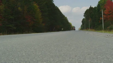 Motorcycle Travelling Down Empty Highway in Autumn - AERIAL Stock Footage 32968816