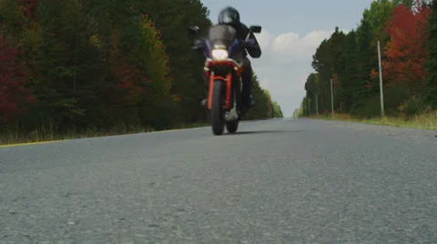 Motorcycle Travelling Down Empty Highway in Autumn Stock Footage 33045001