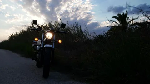 Motorcycle with warning lights on a windy late evening Video stock 139540243