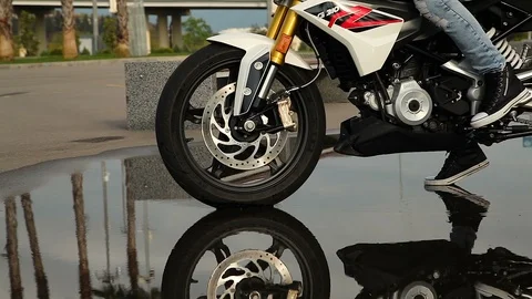 Motorcycle wheels pass through the water Stock Footage 114559457