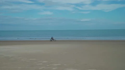 The motorcycle will drive along the sandy coast of the ocean Stock Footage 227299360