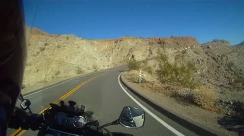 Motorcycle on winding desert road Stock Footage 10722883