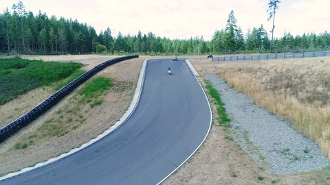 Motorcycles coming around a bend Stock Footage 126306571