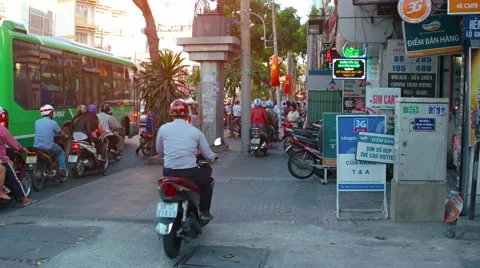 Motorcycles driving on a sidewalk to avoid traffic in Ho Chi Minh City Stockbeeldmateriaal 63449728