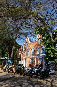 Motorcycles parked on Doria Vasconcelos street under tree shade Stock Photos