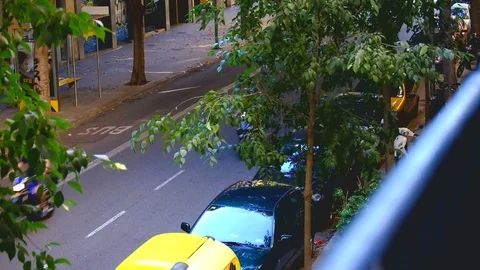 Motorcycles passing fast in a street in the Eixample district, Barcelona Stock Footage 83038464