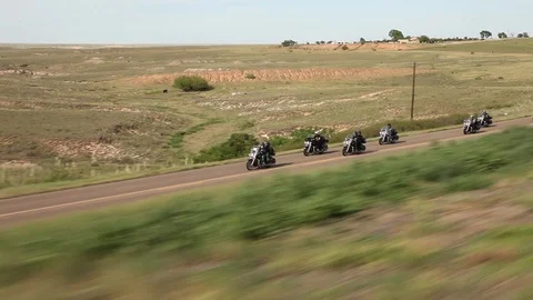 Motorcycles riding through green fields 스톡 동영상 105230544